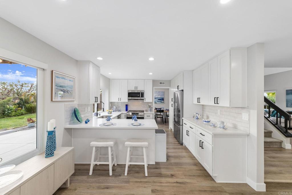 460 Compass Road Oceanside, CA 92054 - Photo 13 of 45 a dining hall with stainless steel appliances kitchen island granite countertop a dining table chairs and view living room