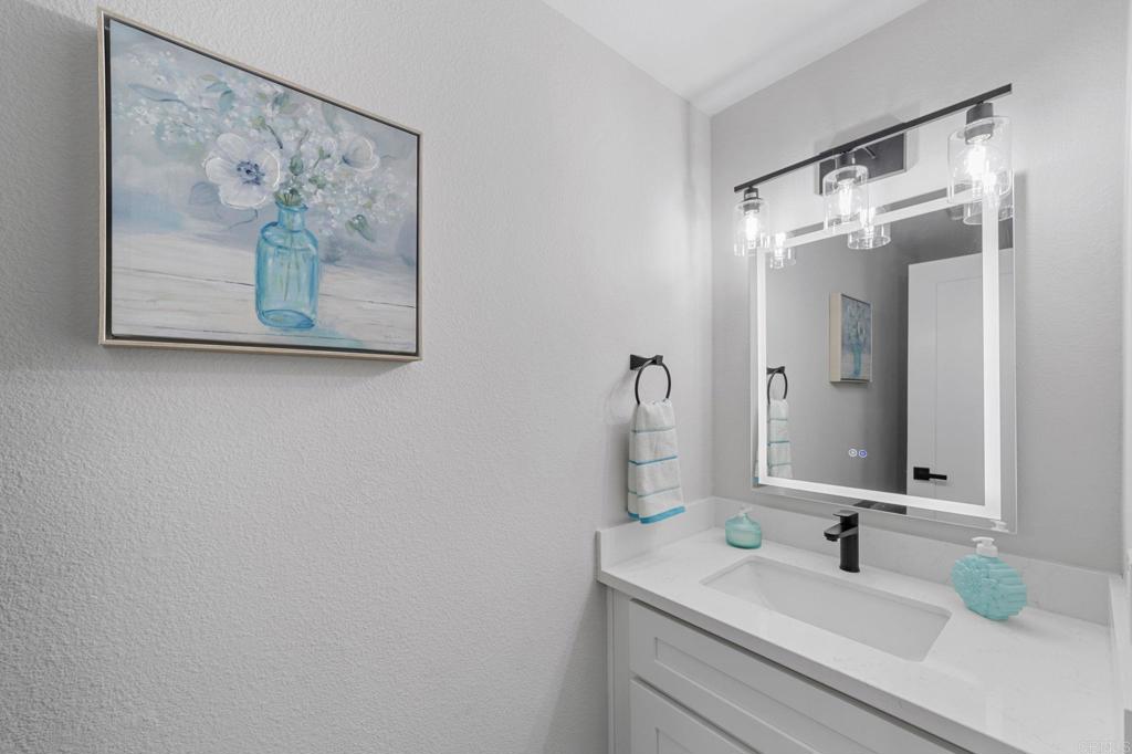 460 Compass Road Oceanside, CA 92054 - Photo 20 of 45 a bathroom with a sink and a mirror
