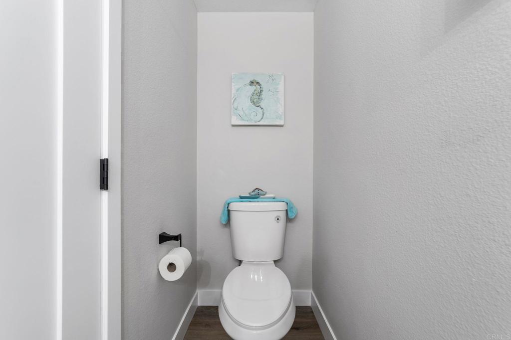 460 Compass Road Oceanside, CA 92054 - Photo 21 of 45 a white toilet sitting next to a bathroom sink