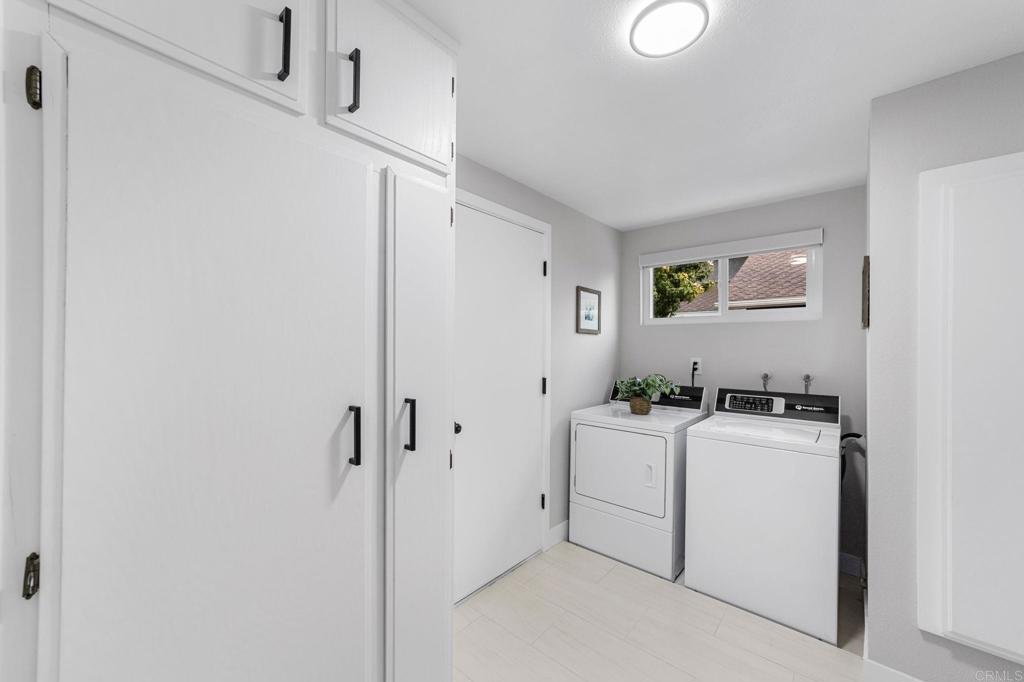 460 Compass Road Oceanside, CA 92054 - Photo 22 of 45 a room with a white stove next to a white cabinet with grey walls