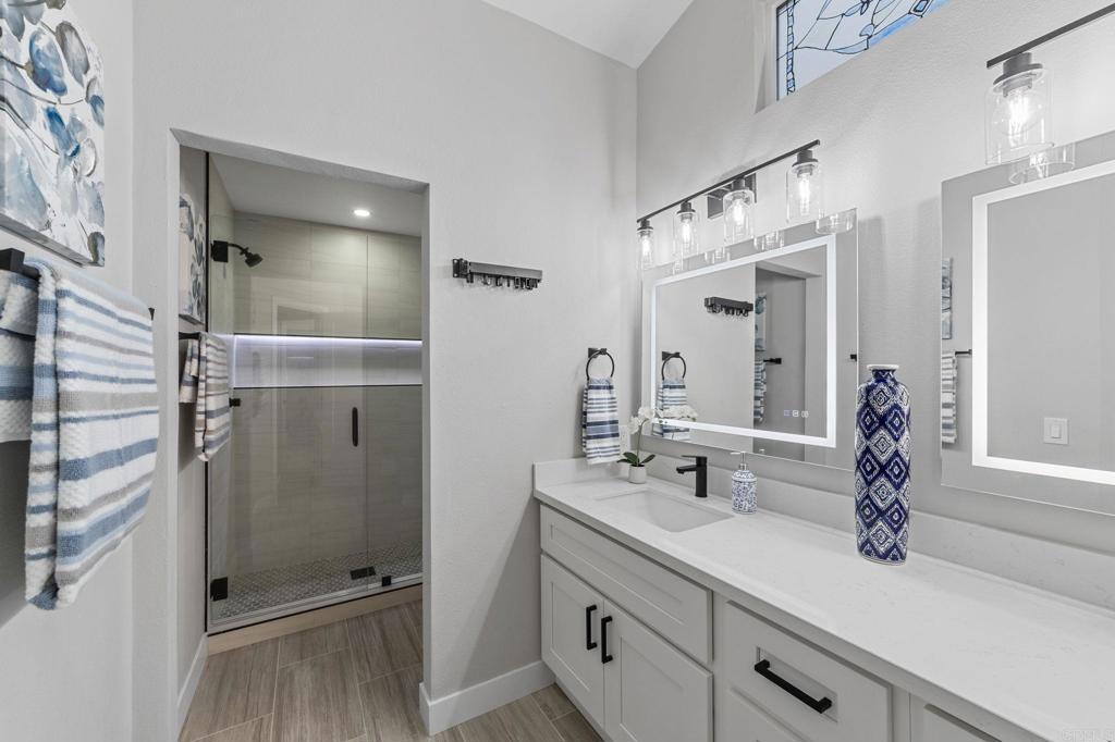 460 Compass Road Oceanside, CA 92054 - Photo 27 of 45 a bathroom with a shower sink and mirror