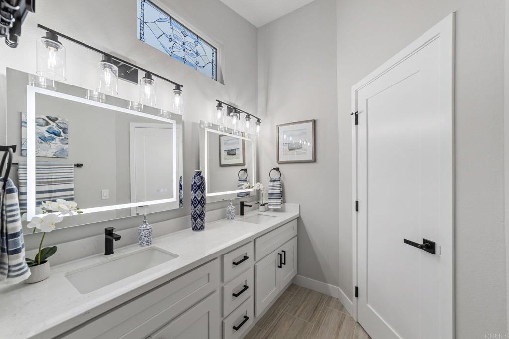 460 Compass Road Oceanside, CA 92054 - Photo 29 of 45 a bathroom with double vanity and a mirror
