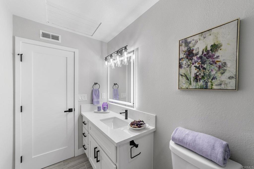 460 Compass Road Oceanside, CA 92054 - Photo 39 of 45 a bathroom with a sink and a mirror
