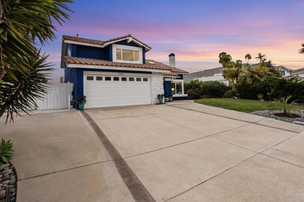 460 Compass Road Oceanside, CA 92054 - Photo 45 of 45 a front view of a house with a yard and garage