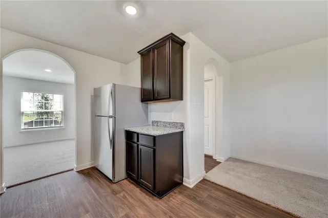 a view of kitchen with stainless steel appliances cabinets and wooden floor