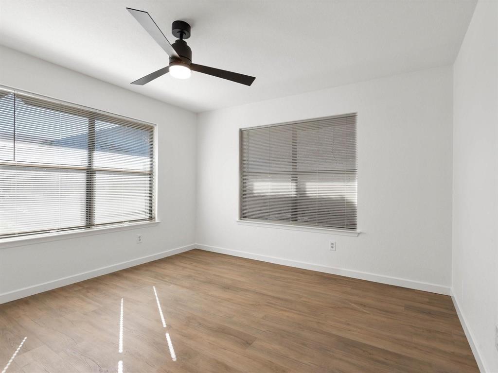 1117 South Rusk Street, Unit 1117 Weatherford, TX 76086 - Photo 6 of 16 Spare room with wood finished floors and a ceiling fan