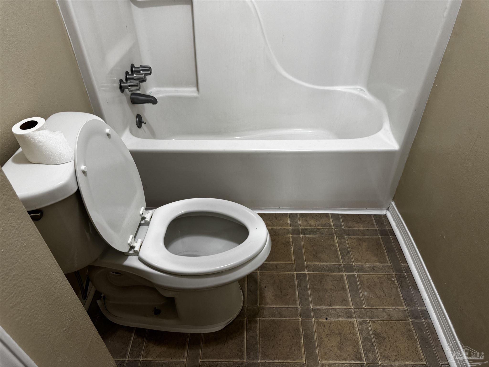 8210 Kipling Street, Unit B Pensacola, FL 32514 - Photo 13 of 17 a bathroom with a toilet and bathtub