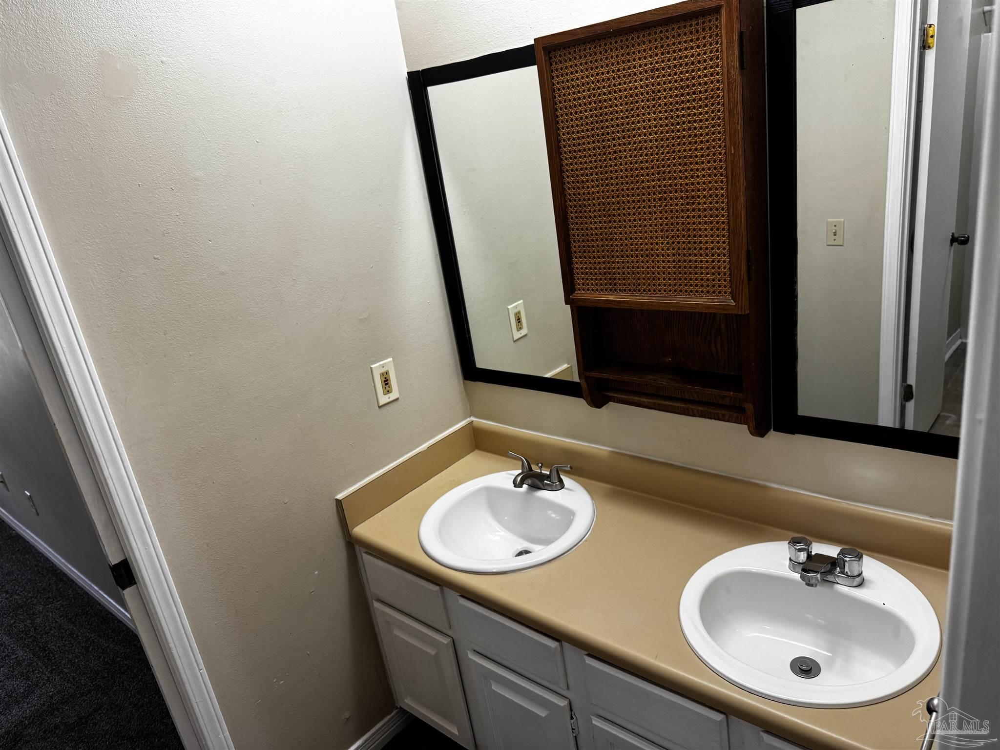 8210 Kipling Street, Unit B Pensacola, FL 32514 - Photo 15 of 17 a bathroom with a sink and a mirror