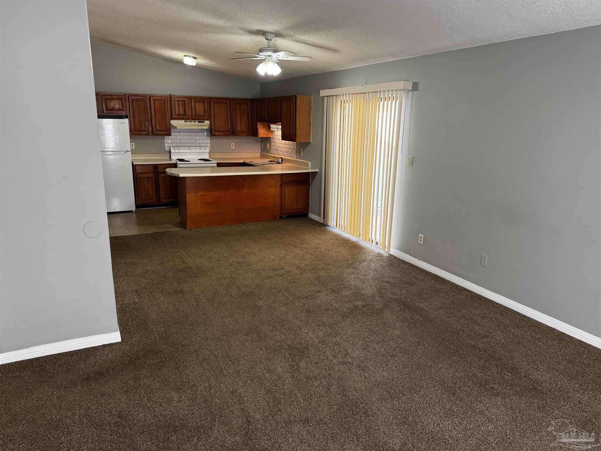 8210 Kipling Street, Unit B Pensacola, FL 32514 - Photo 5 of 17 a view of kitchen and kitchen with window