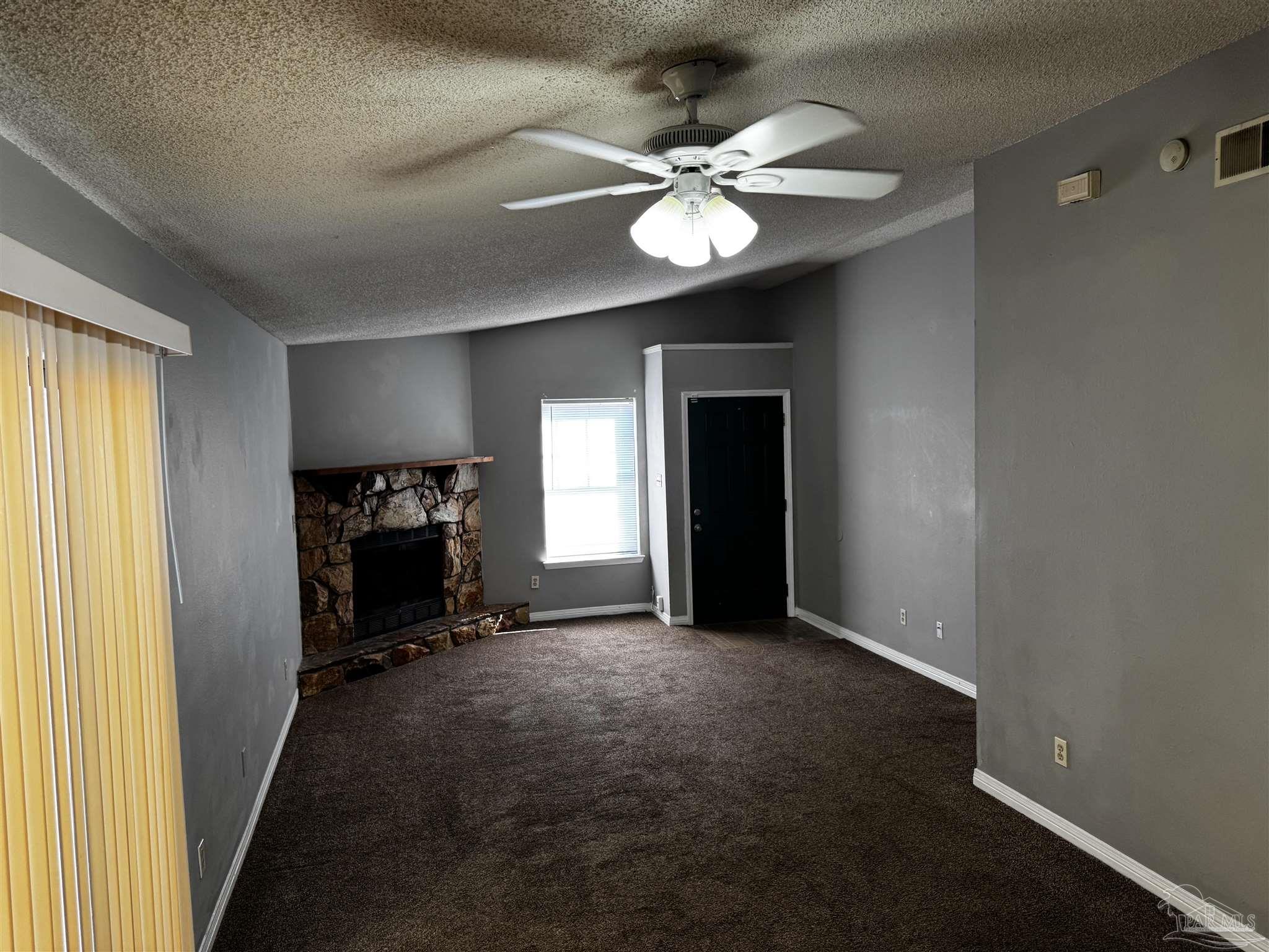 8210 Kipling Street, Unit B Pensacola, FL 32514 - Photo 6 of 17 a view of an empty room with window and fire place