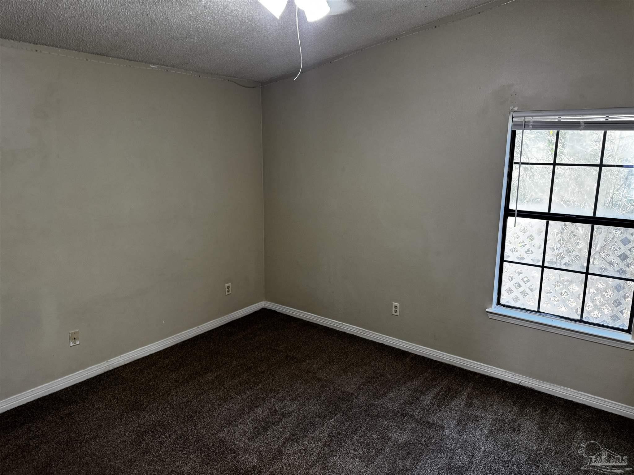 8210 Kipling Street, Unit B Pensacola, FL 32514 - Photo 9 of 17 an empty room with a window