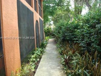 18230 Mediterranean Boulevard, Unit 1306 Hialeah, FL 33015 - Photo 15 of 15 a view of a pathway of a garden