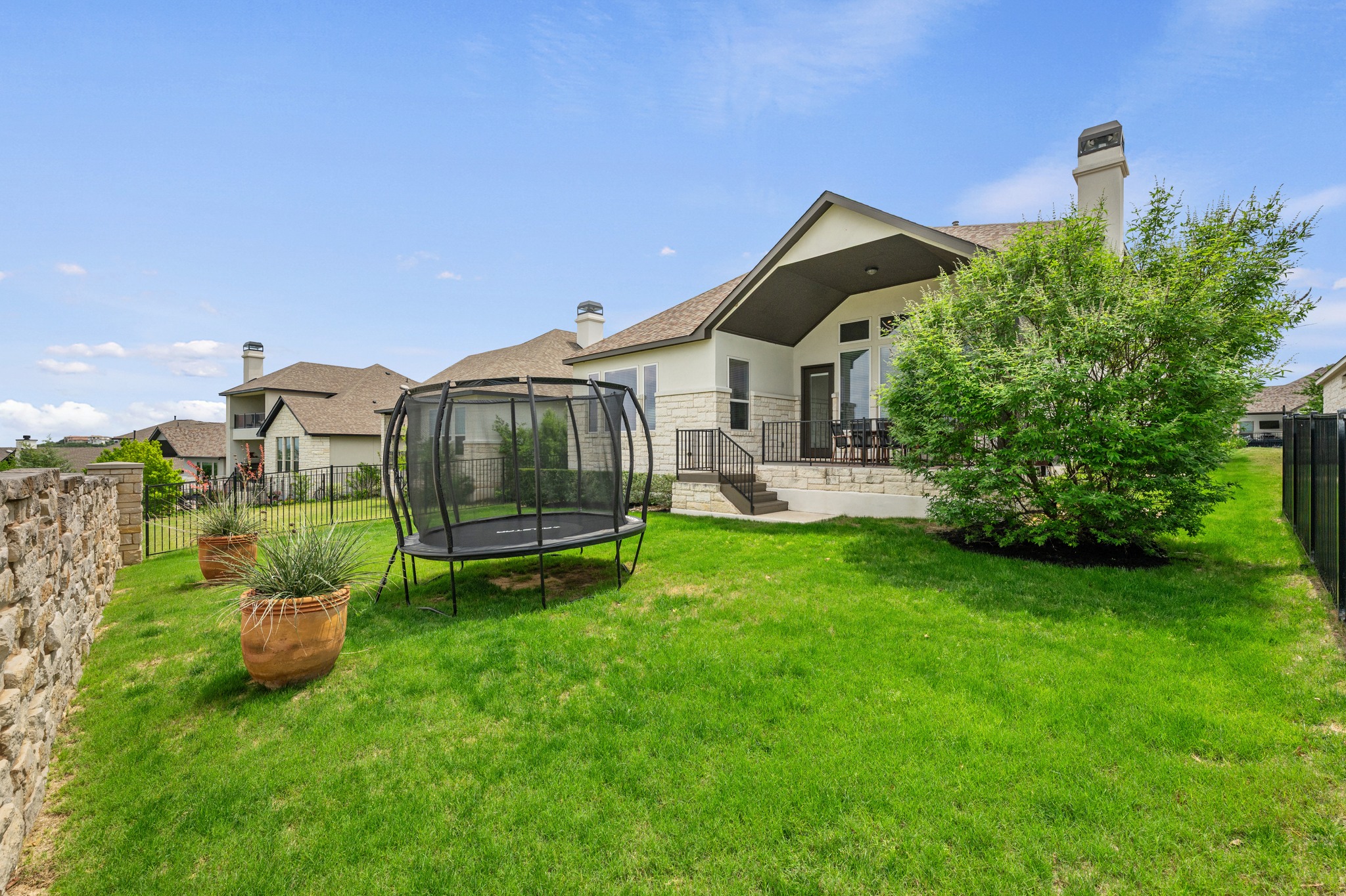 510 Elworth Path Austin, TX 78738 - Photo 28 of 40 a front view of a house with a garden and yard