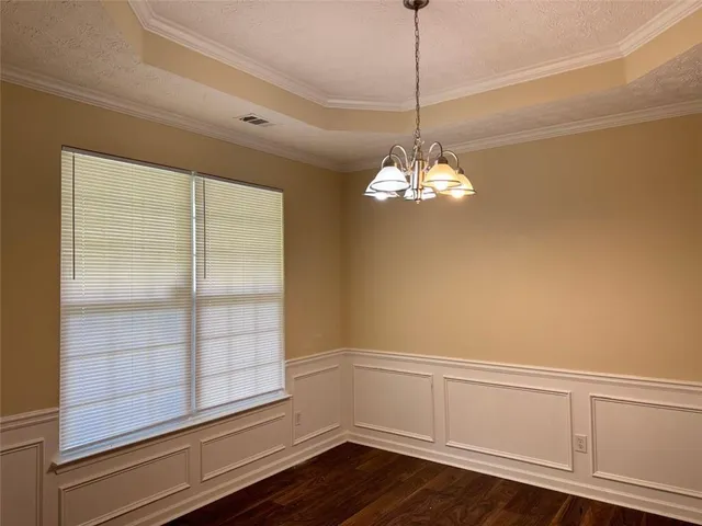 a view of a room with wooden floor and windows