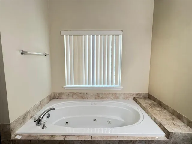 a white bath tub sitting in a bathroom