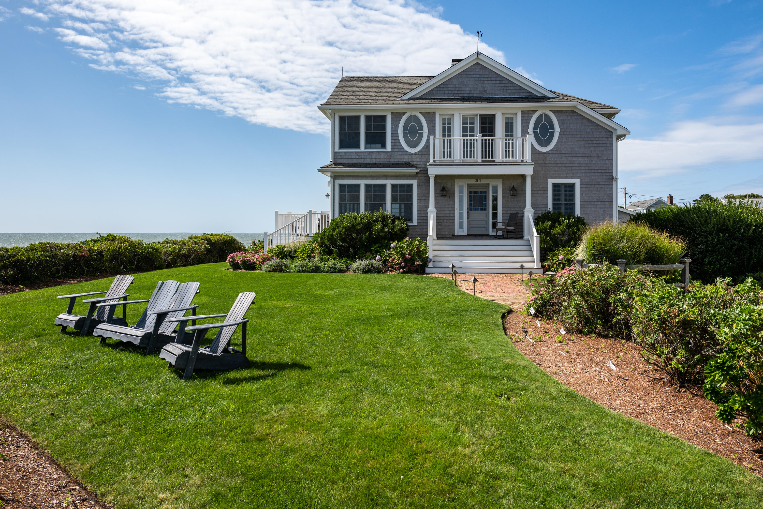 31 Starboard Lane Mashpee, MA 02649 - Photo 4 of 49 a front view of a house with a garden