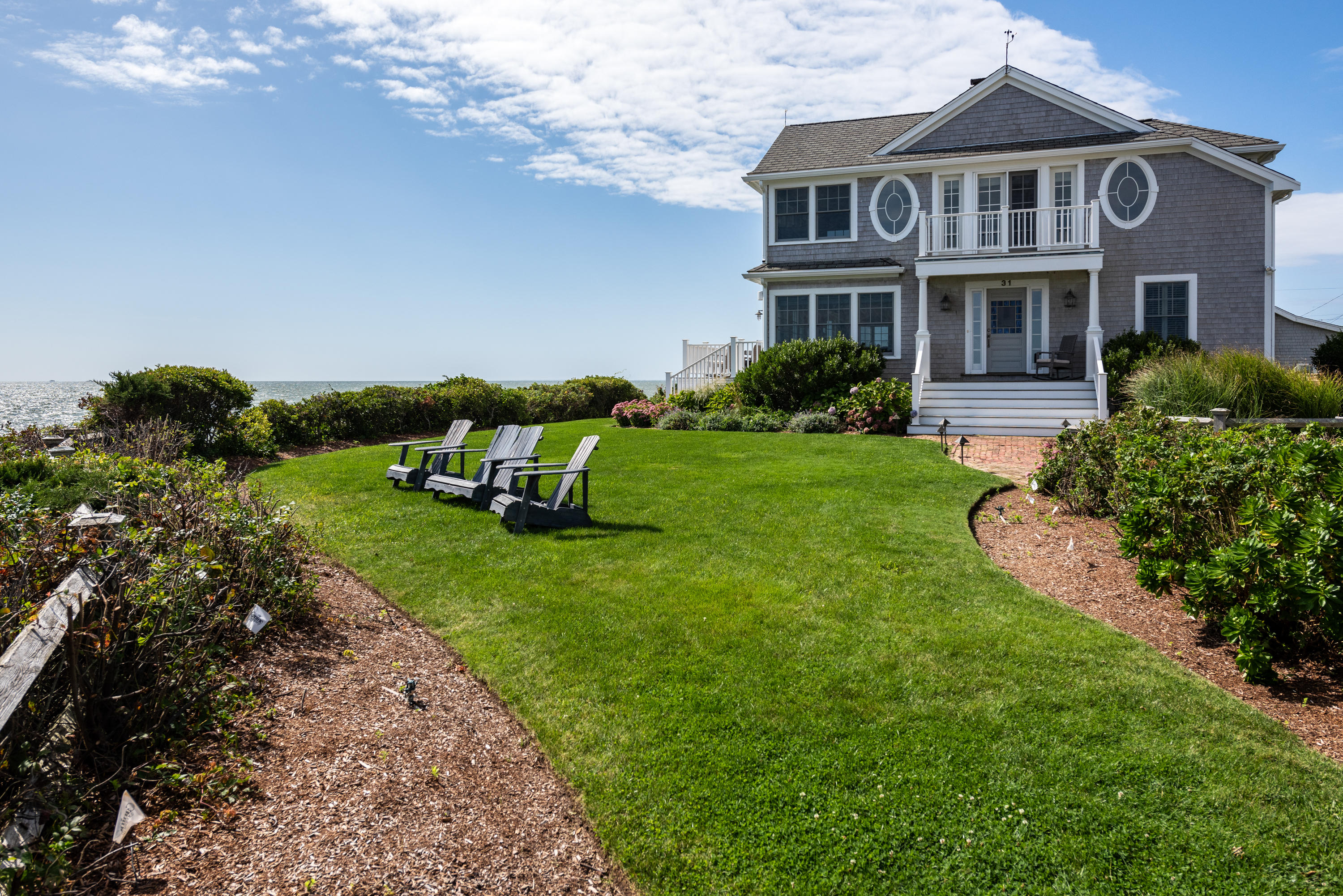31 Starboard Lane Mashpee, MA 02649 - Photo 5 of 49 a front view of a house with a garden