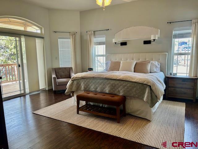 16609 Columbine Lane Cedaredge, CO 81413 - Photo 31 of 39 a bedroom with a bed couch and a large window