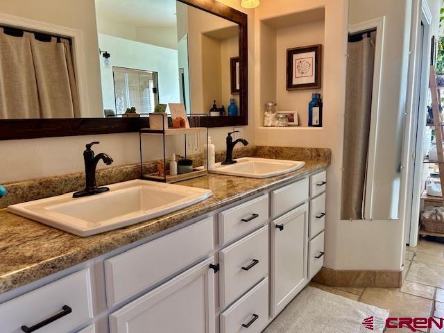 16609 Columbine Lane Cedaredge, CO 81413 - Photo 34 of 39 a bathroom with double sink and a mirror