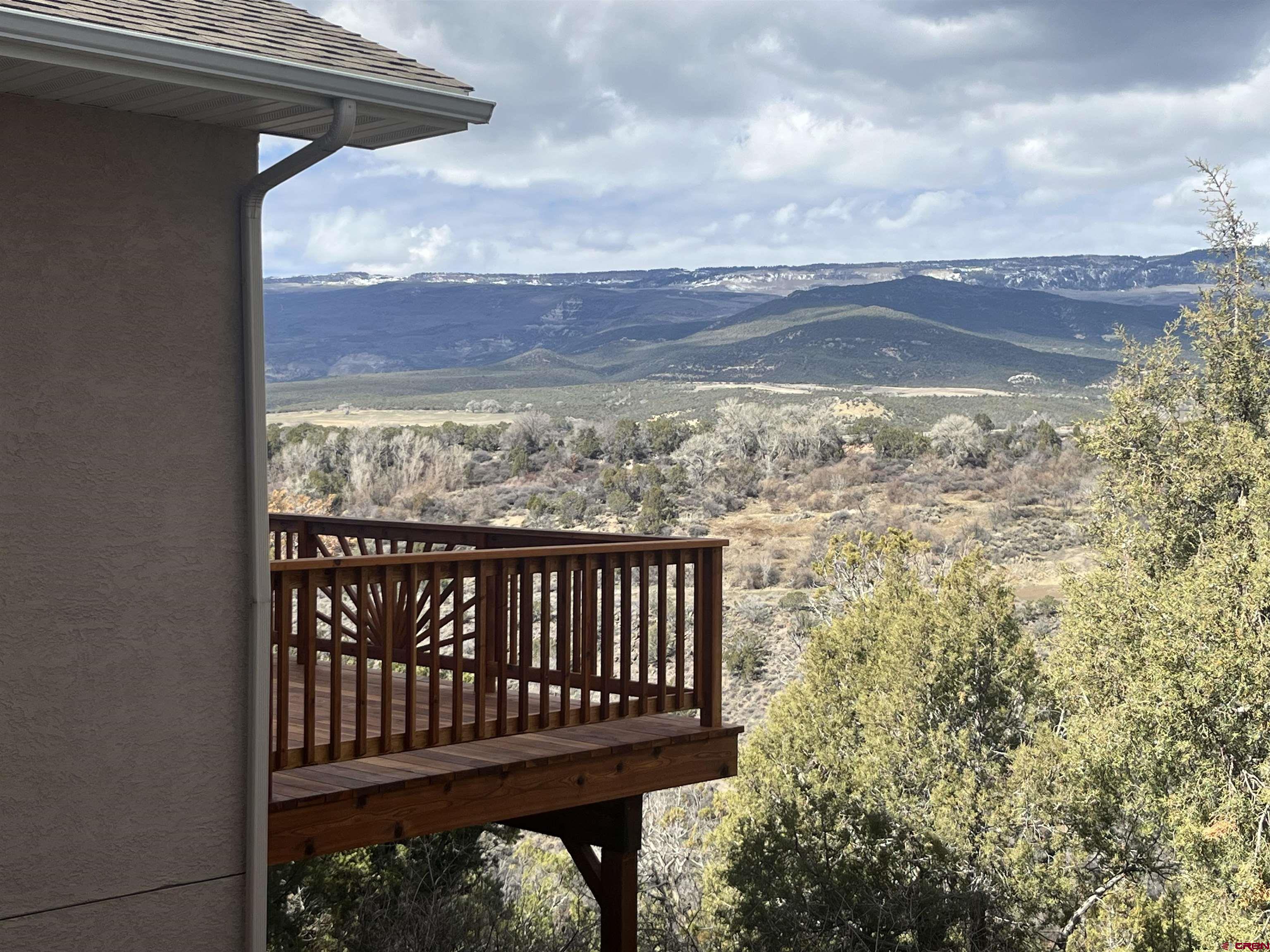 16609 Columbine Lane Cedaredge, CO 81413 - Photo 9 of 39 a view of a roof deck with chair and wooden floor