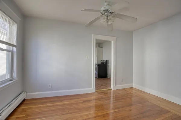 wooden floor in an empty room with a window