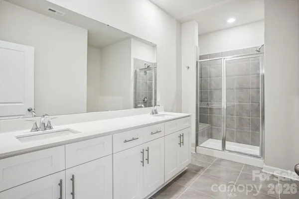 a bathroom with a shower sink and mirror