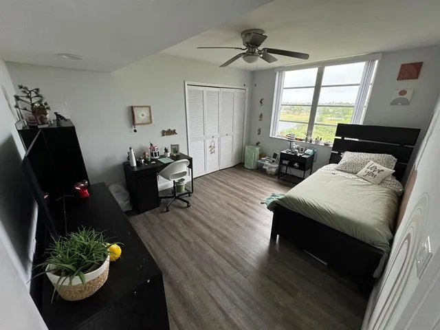 a living room with furniture flowerpot and window