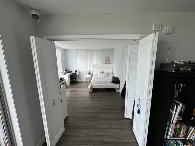 a living room with furniture and a book shelf