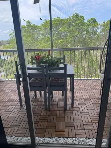 a view of a chairs and table in the balcony