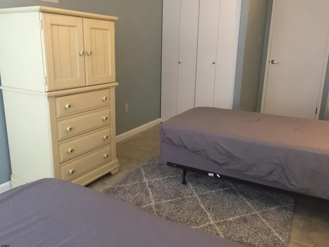 a bedroom with a bed and chair
