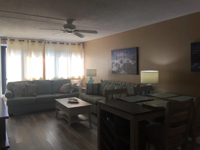 a living room with furniture a window and a flat screen tv