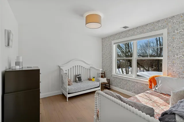 a bedroom with furniture and a window