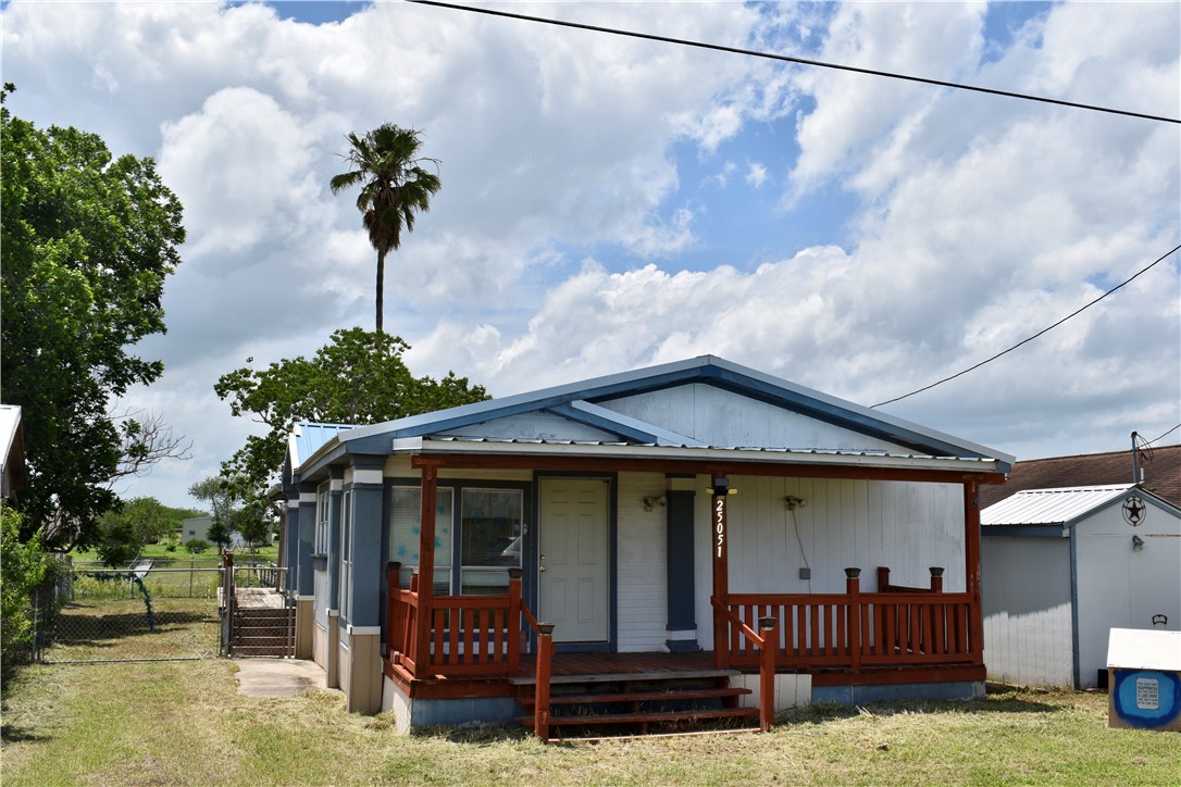 25051 Lake Shore Drive Mathis, TX 78368 - Photo 1 of 40 a front view of a house with garden