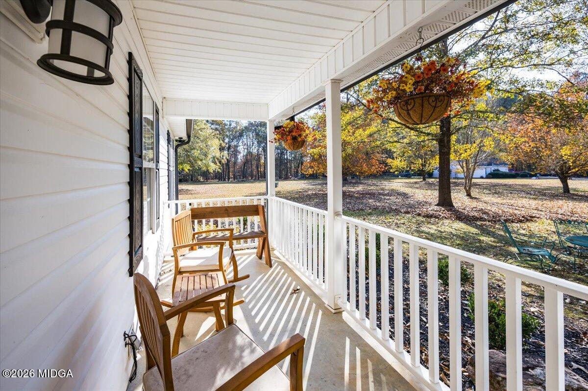 428 Fairview Church Road Forsyth, GA 31029 - Photo 23 of 35 a view of a porch with wooden floor and fence