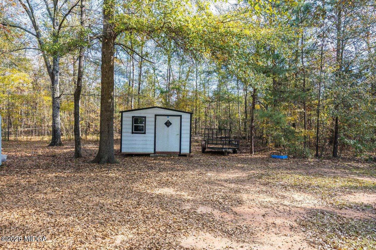 428 Fairview Church Road Forsyth, GA 31029 - Photo 26 of 35 a view of a house with a large tree and wooden fence