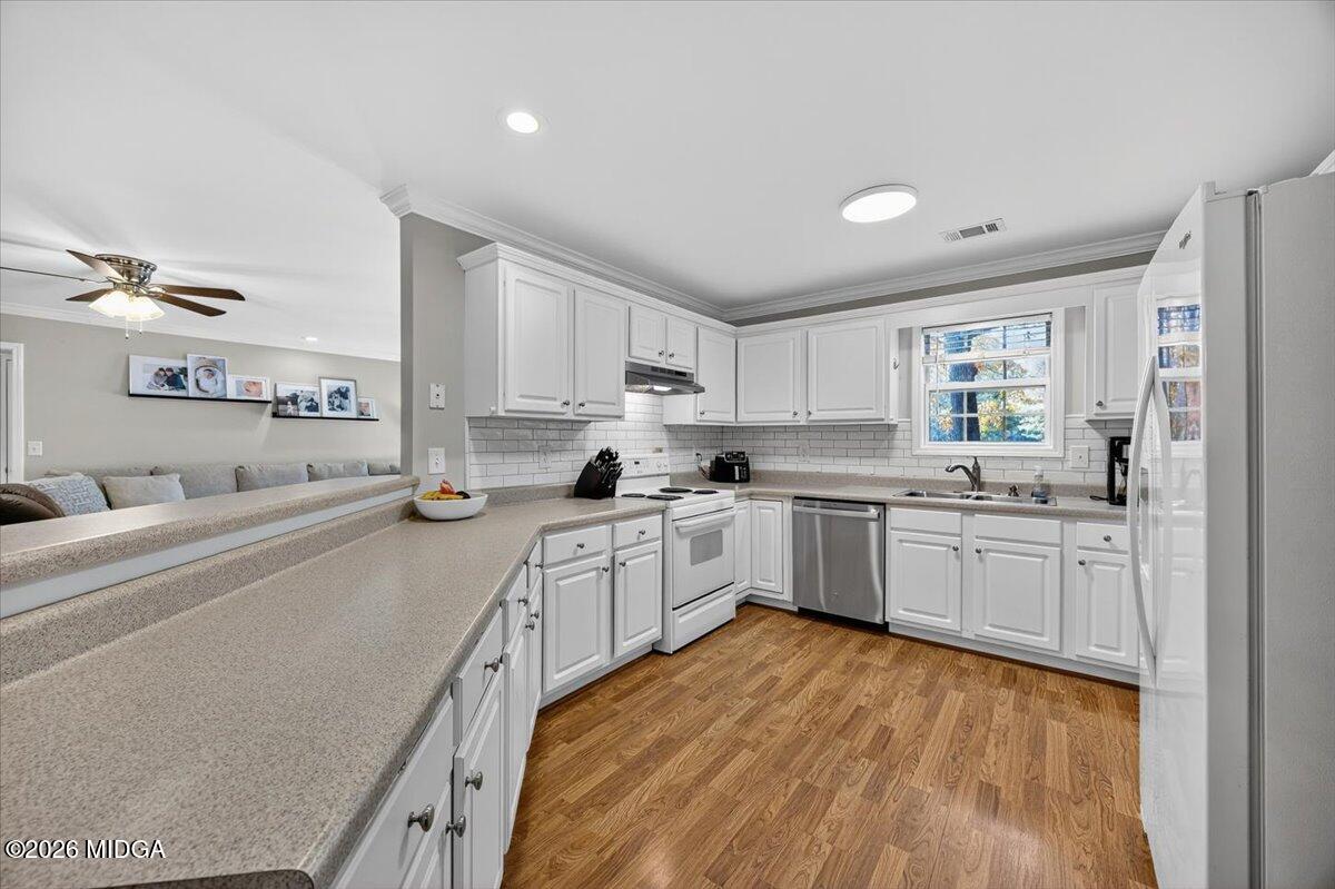 428 Fairview Church Road Forsyth, GA 31029 - Photo 8 of 35 a kitchen with granite countertop a sink cabinets stainless steel appliances and a window