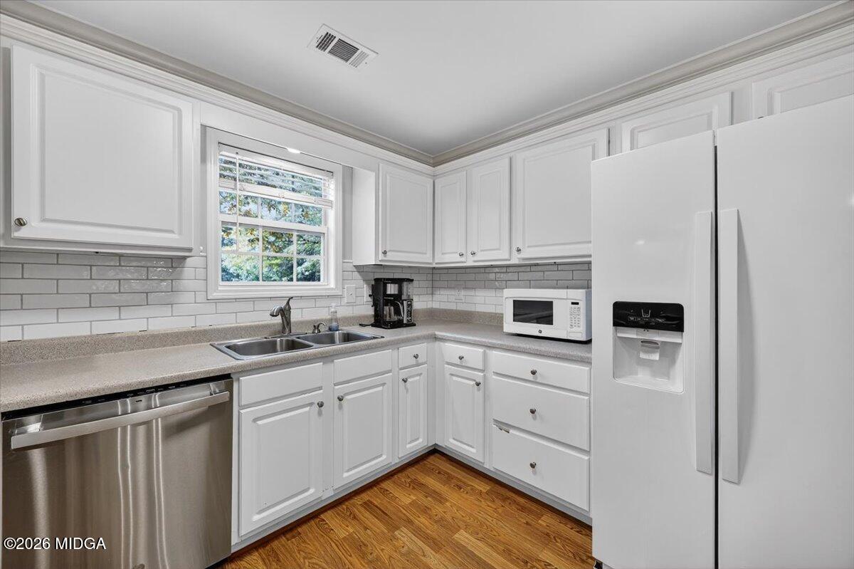 428 Fairview Church Road Forsyth, GA 31029 - Photo 9 of 35 a kitchen with white cabinets and white appliances