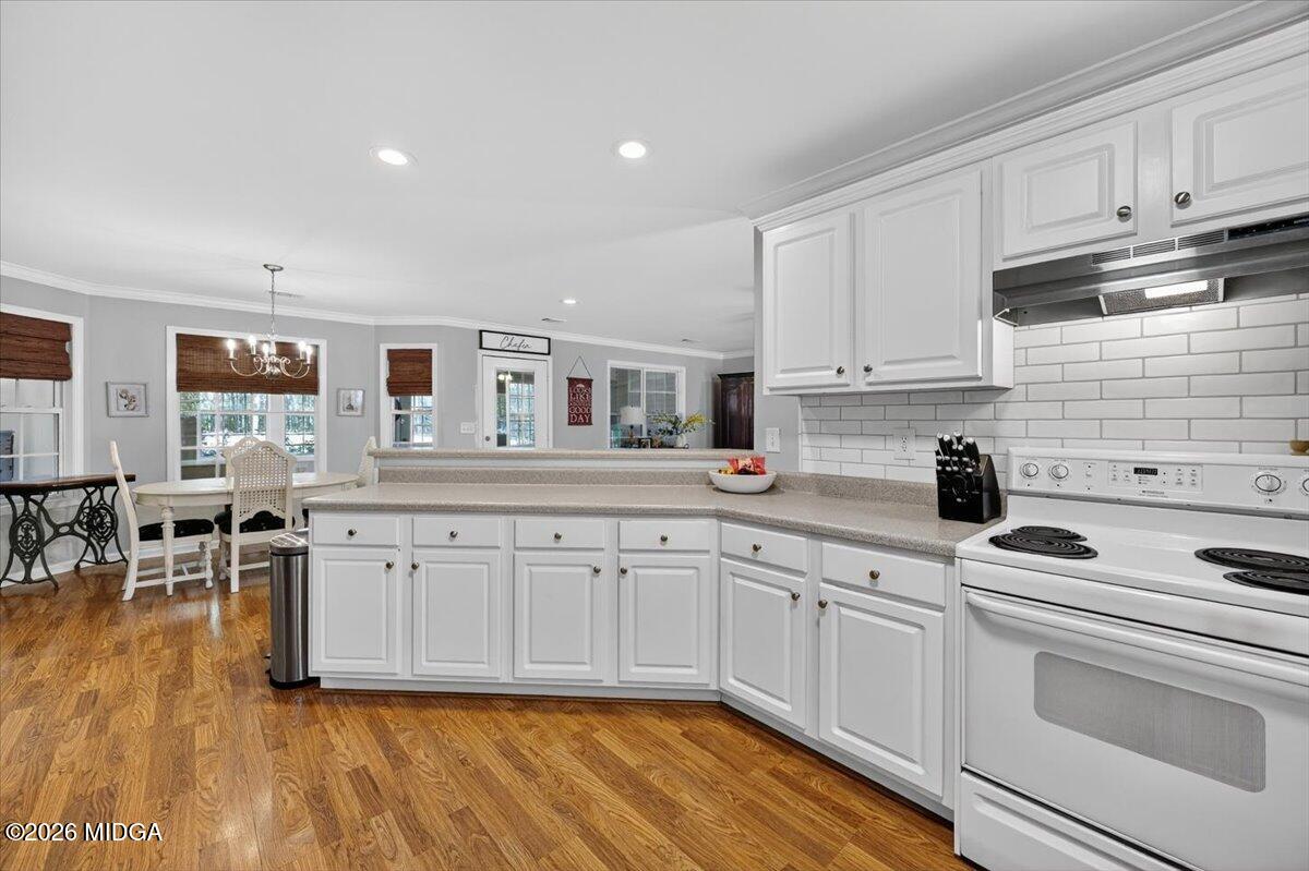 428 Fairview Church Road Forsyth, GA 31029 - Photo 10 of 35 a kitchen with granite countertop a stove sink and cabinets