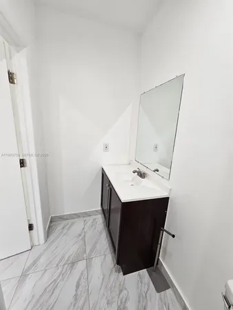 a bathroom with a sink and mirror