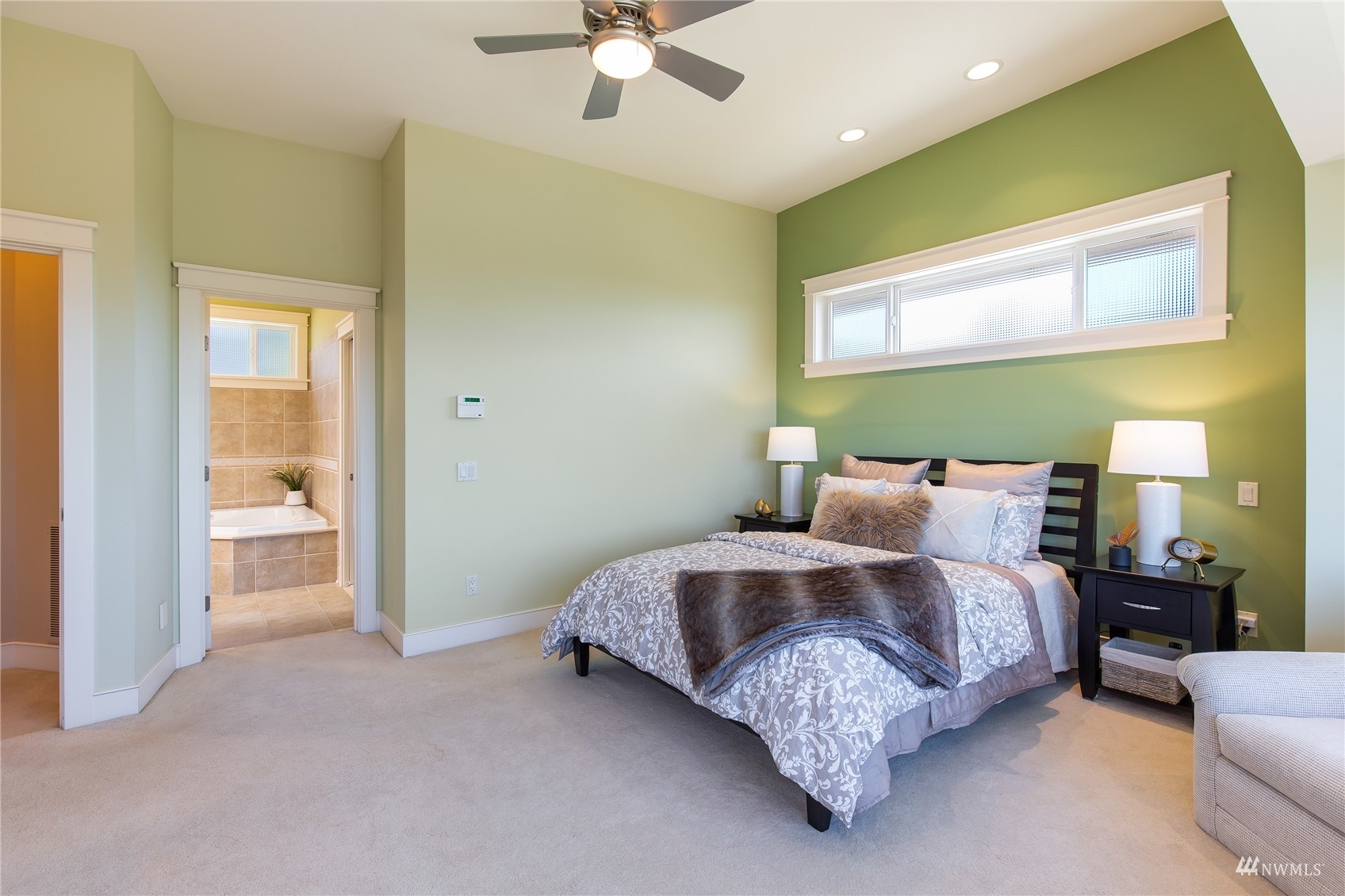 731 Bell Street Edmonds, WA 98020 - Photo 14 of 40 a bed room with a bed and a chandelier