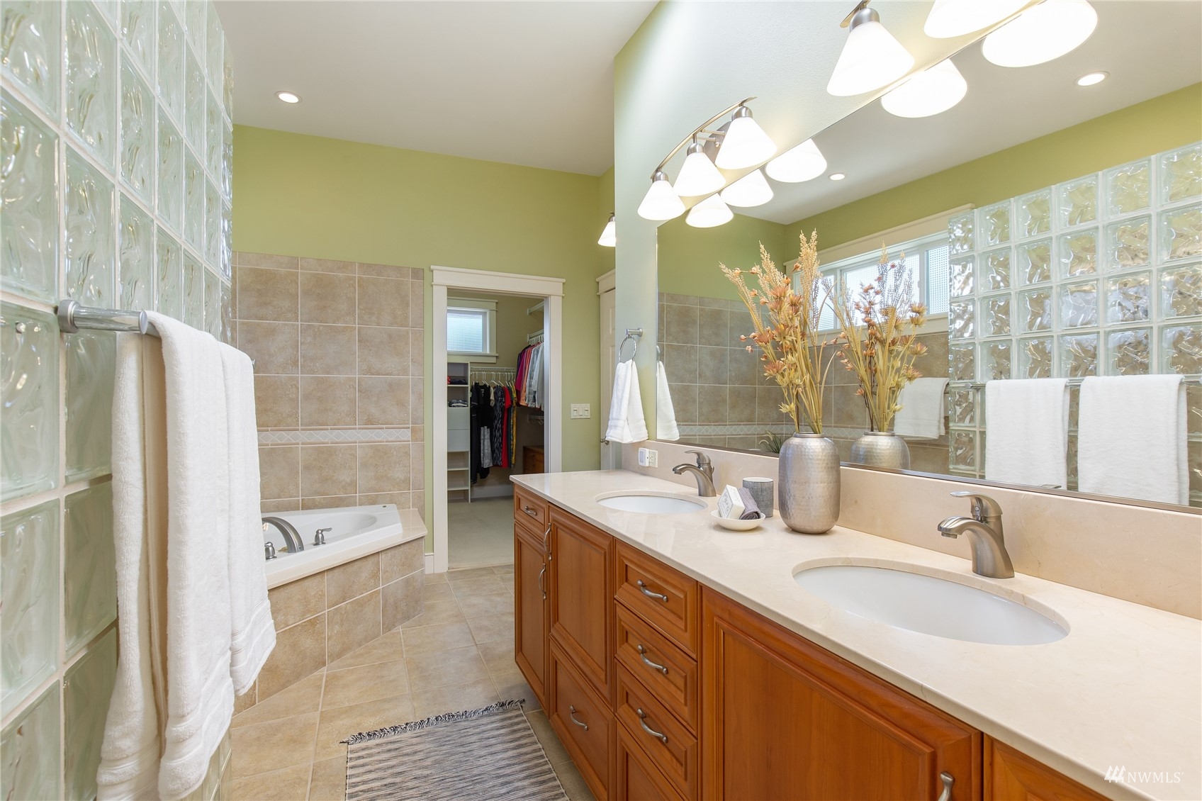 731 Bell Street Edmonds, WA 98020 - Photo 17 of 40 a spacious bathroom with a double vanity sink a large mirror and a bathtub