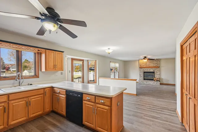 a large kitchen with stainless steel appliances granite countertop a lot of counter space and wooden floors