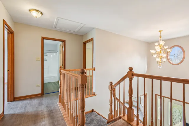 a view of a hallway with windows and stairs