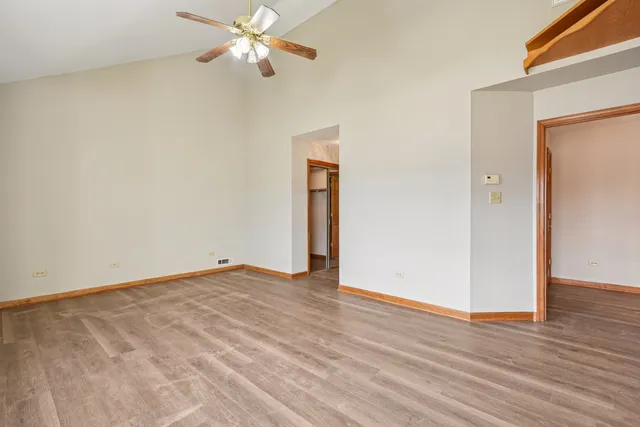 a view of an empty room with wooden floor