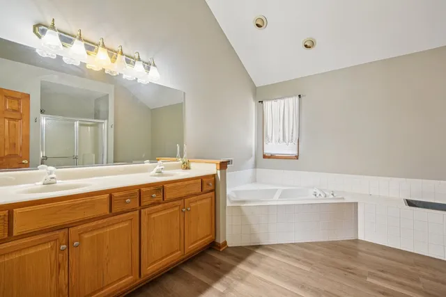 a spacious bathroom with a bathtub sink and mirror