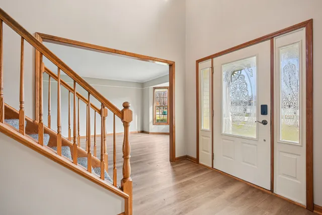 a view of an entryway with wooden floor