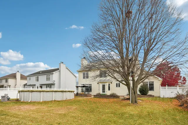 a large white building with a large tree in front of it