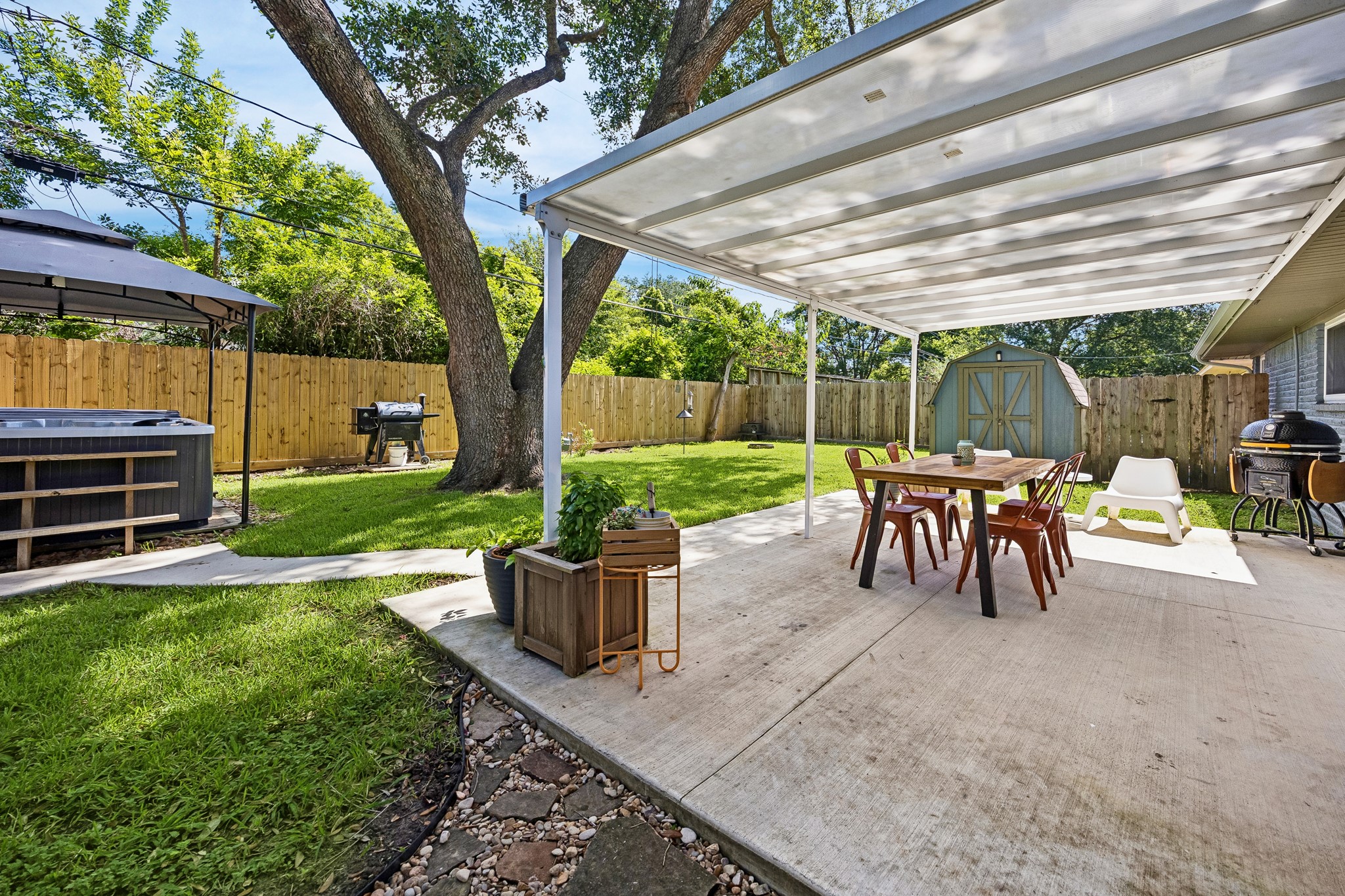 4514 Warm Springs Road Houston, TX 77035 - Photo 6 of 31 This backyard offers a workshop shed. The gate next to it opens to a lawn tool storage area to keep the landscape tidy.