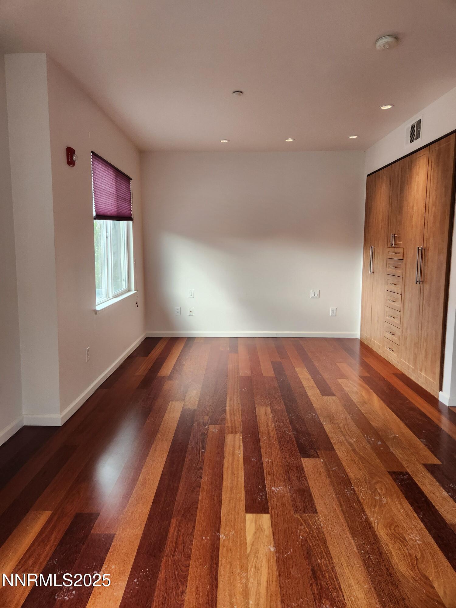 1450 Idlewild Drive, Unit 1133 Reno, NV 89509 - Photo 4 of 6 a view of room with window and wooden floor