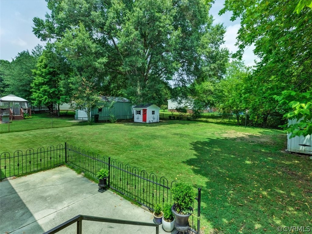 4140 Holcombe Road Richmond, VA 23234 - Photo 15 of 18 a view of a backyard with a garden